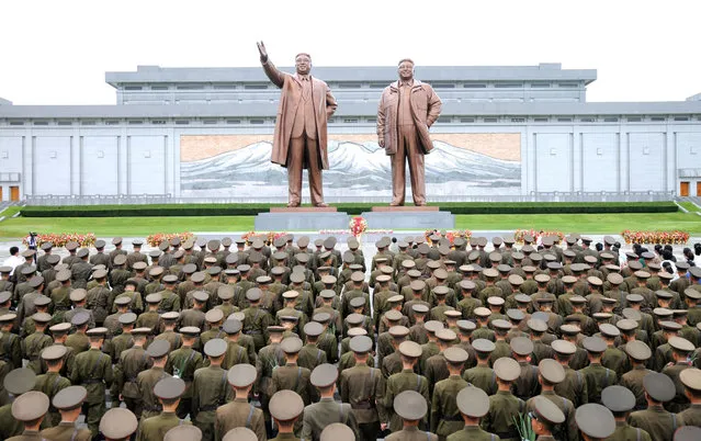 Servicepersons of the Korean People's Army (KPA) and the Korean People's Internal Security Forces (KPISF), civilians, school youth and children visited the statues of President Kim Il Sung and leader Kim Jong Il on the occasion of the 72nd anniversary of national liberation in this undated photo released by North Korea's Korean Central News Agency (KCNA) on August 15, 2017. (Photo by Reuters/KCNA)
