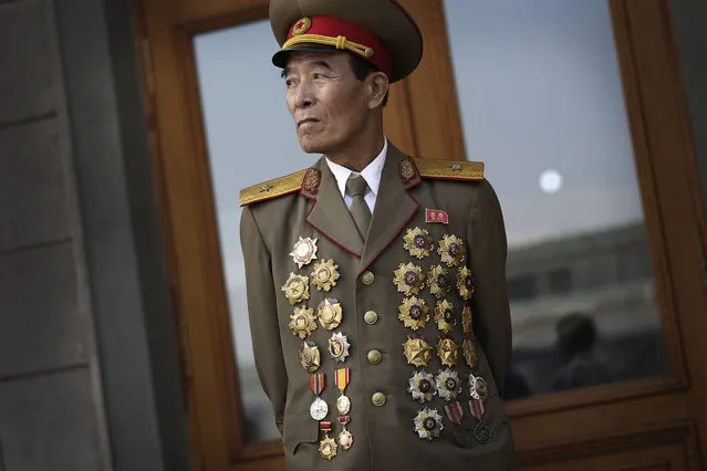 North Korean war veteran Kim Jae Pung, 78, a retired general, is decorated with medals as he attends a parade to celebrate the anniversary of the Korean War armistice agreement, Sunday, July 27, 2014, in Pyongyang, North Korea. North Koreans gathered at Kim Il Sung Square as part of celebrations for the 61st anniversary of the armistice that ended the Korean War. (Photo by Wong Maye-E/AP Photo)