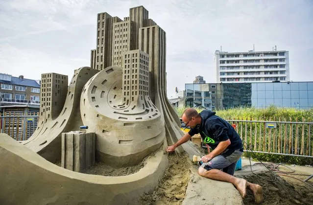 Dutch artist Maxim Gazendam works on his sand sculpture during the third edition of the European Championship Sand Sculpting 2014 in Zandvoort aan Zee, The Netherlands, 08 August 2014. Eight sculptors from different European countries will each create an impressive sculpture on the main theme “Music and Dance”. (Photo by Remko De Waal/EPA)