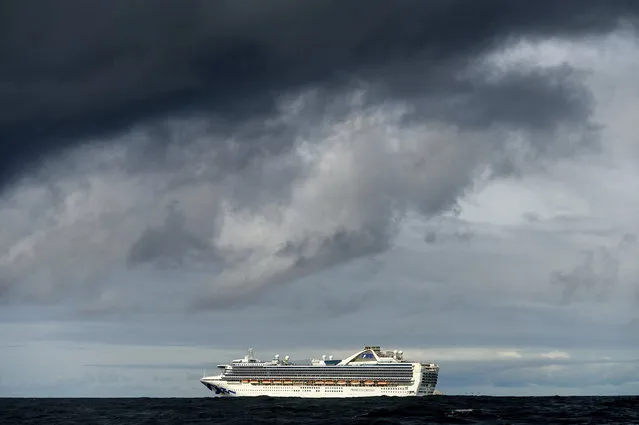 Carrying multiple people who have tested positive for COVID-19, the Grand Princess maintains a holding pattern about 30 miles off the coast of San Francisco, Sunday, March 8, 2020. The cruise ship is scheduled to dock at the Port of Oakland on Monday. (Photo by Noah Berger/AP Photo)