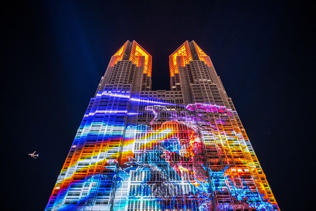 The Tokyo Metropolitan Government building is lit up with the projection mapping program “TOKYO GODZILLAs”, which is a follow-up to the presentation released in spring this year, in Tokyo on November 30, 2024. (Photo by Philip Fong/AFP Photo)