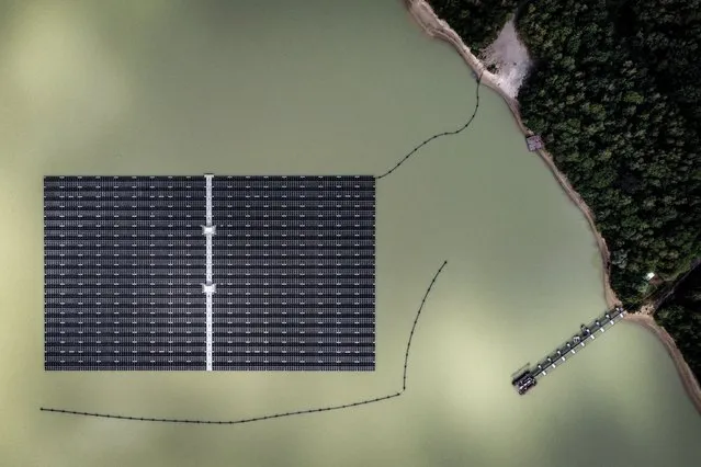 An aerial photo taken with a drone shows solar panels on Germany's biggest floating photovoltaic plant on lake Silbersee in Haltern, Germany, 27 July 2022. More than 5,000 photovoltaic modules produce around 3 million kilowatt hours of electricity per year, saving 1,100 tons of CO2 to fight climate change with renewable power instead of oil, gas and coal. (Photo by Sascha Steinbach/EPA/EFE)