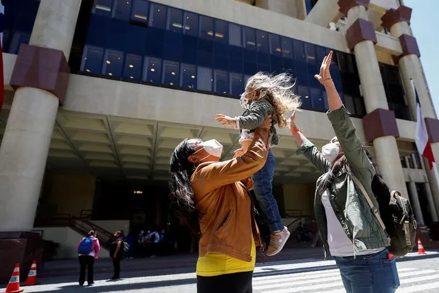 A couple reacts with their daughter outside the Congress as the Senate votes to approve a same-s*x marriage bill in Valparaiso, Chile on December 7, 2021. (Photo by Rodrigo Garrido/Reuters)
