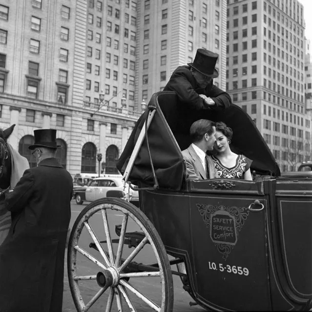 This 1953 photo provided by the Estate of Vivian Maier and John Maloof Collection shows a couple riding in a horse-drawn carriage in New York. (Photo by Vivian Maier/Estate of Vivian Maier and John Maloof Collection via AP Photo)
