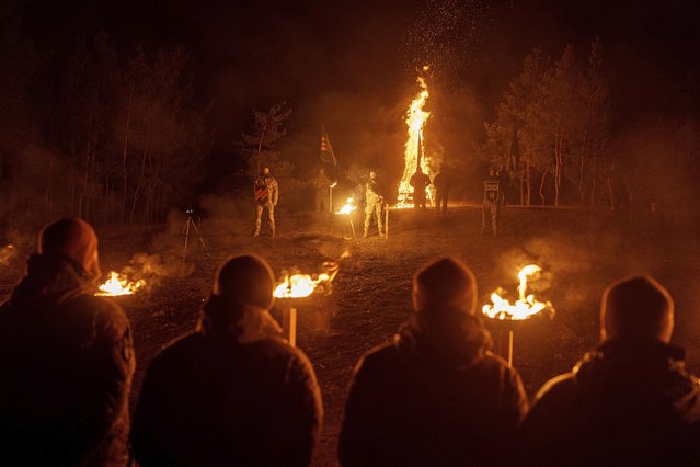 Ukrainian servicemen of 3rd assault brigade participate memorial ceremony of their fallen comrades during the winter solstice in Kharkiv region, Ukraine, December 22, 2024. (Photo by Evgeniy Maloletka/AP Photo)