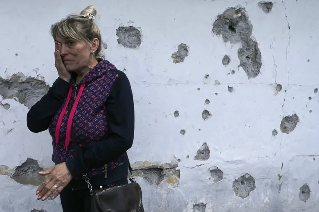 Tatyana Lystopad, 57, weeps near the wall of her house, which was damaged by shrapnel of artillery shooting in pro-Russian militants controlled village of Staromihailovka, Donetsk area, Ukraine, 19 May 2020. Any direct negotiations with Russian-controlled militants are off the table. “We only negotiate in the trilateral format: the TCG includes Russia, Ukraine, and the OSCE” assures Vice Prime Minister, Minister for Reintegration of Temporarily Occupied Territories, First Deputy Representative of Ukraine to the Trilateral Contact Group for the Donbas settlement, Oleksiy Reznikov on 18 May 2020. (Photo by Dave Mustaine/EPA/EFE)