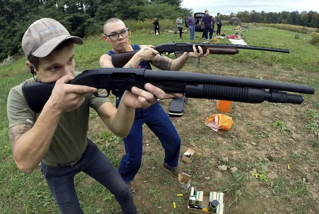 In this October 8, 2017, photo, Jon Falstaff, left, shows Emily Lynch how to properly stand and hold a shotgun during a training session for the Trigger Warning Queer & Trans Gun Club in Victor, N.Y. (Photo by Adrian Kraus/AP Photo)