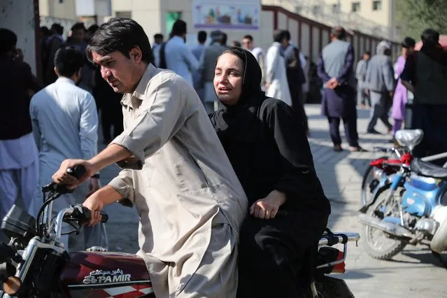 A woman arrives on a motorbike to search for a relative at a hospital in Kabul on September 30, 2022 after a blast in a learning centre in the Dasht-e-Barchi area of Afghanistan's capital. (Photo by AFP Photo/Stringer)