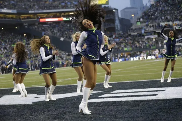 Seattle Seahawks cheerleaders perform against the San Francisco 49ers during the first half of the NFL football NFC Championship game Sunday, January 19, 2014, in Seattle. (Photo by Marcio Jose Sanchez/AP Photo)