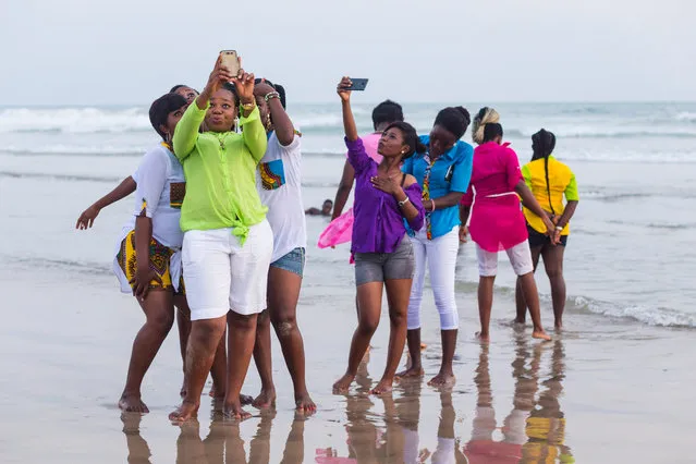 A group of young women take selfies while strolling on Labadi beach, a popular hang out in Ghana’s capital. The photo forms part of a project by Tripod City, a photographic collaboration between Charlie Kwai, Chris Lee and Paul Storrie, who visited the country to capture contemporary Ghanaian culture. (Photo by Chris Lee/The Guardian)