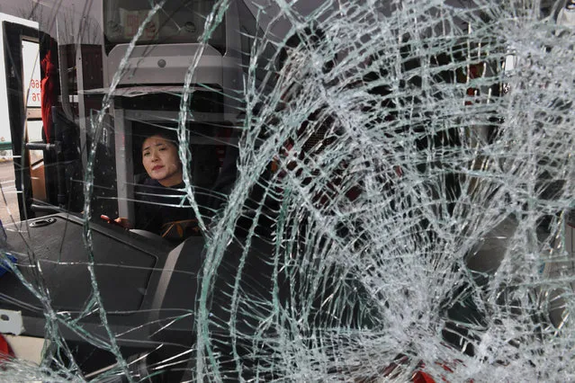 A woman looks on from a vehicle after a pile-up accident on an expressway section in Fuyang city, Anhui province, China on November 15, 2017. (Photo by Reuters/China Stringer Network)