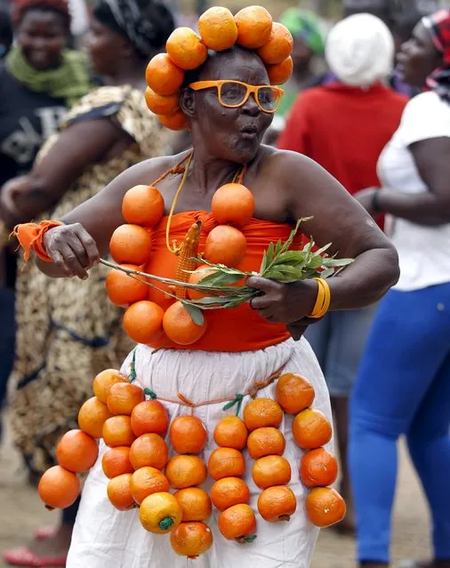 A supporter of Kenya's opposition Coalition for Reforms and Democracy (CORD), adorned with oranges, attends their rally at Uhuru Park grounds in a show of solidarity with teachers currently engaged in a national striker over a pay increase dispute, in capital Nairobi, September 23, 2015. (Photo by Thomas Mukoya/Reuters)