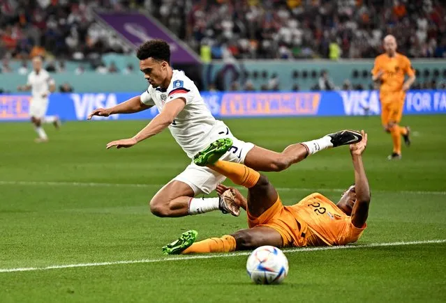 Antonee Robinson of United States and Denzel Dumfries of Holland (LR) during the FIFA World Cup Qatar 2022 round of 16 match between the Netherlands and the United States at Khalifa International stadium on December 3, 2022 in AL-Rayyan, Qatar. (Photo by Dylan Martinez/Reuters)