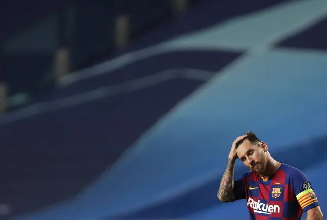 Barcelona's Lionel Messi holds his head during the Champions League quarterfinal match between FC Barcelona and Bayern Munich at the Luz stadium in Lisbon, Portugal, Friday, August 14, 2020. (Photo by Manu Fernandez/AP Photo/Pool)