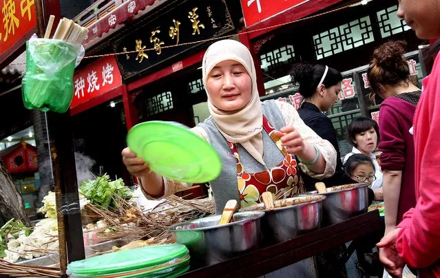 Xi'an's Muslim Quarter is home to around 30,000 people of the city's Hui population, and many of its twisting streets are packed with food stalls, restaurants, souvenir and tea shops. (Photo by Mark Edelson/The Palm Beach Post)