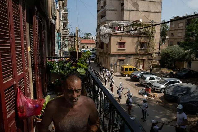 Abdou Batrouni sits on the balcony of his home that was damaged by an explosion at the Beirut port, in the neighbourhood of Karantina, Beirut, Lebanon, August 13, 2020. In one of Beirut's poorest neighborhoods, people are still reeling from the explosion that flattened homes and killed many neighbors who felt like family. Residents are now struggling to find the money to rebuild, without help from the state in a city that was already deep in economic collapse. (Photo by Alkis Konstantinidis/Reuters)
