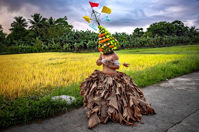 A flagellant wearing dried banana leaves and a colorful headdress whips his back during Good Friday Lenten Rites on March 29, 2024 in Infanta, Quezon province, Philippines. Although the act of self mortification is condemned by the Catholic church and frowned upon in the modern age, thousands of Filipino faithful still practice it to this day as a form of popular piety and has become a part of Philippine tradition in Asia's largest predominantly Roman Catholic nation. (Photo by Ezra Acayan/Getty Images)