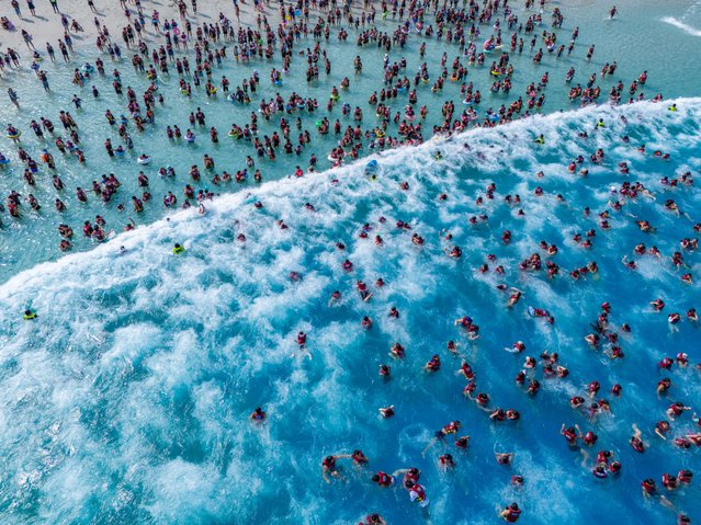 Tourists cool off at a water park in summer on June 21, 2025 in Zhengzhou, Henan Province of China. (Photo by Zuo Dongchen/VCG via Getty Images)