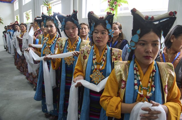 Exiled Tibetan women in traditional attire carry ceremonial scarf as part of the rituals during the 90th birthday celebration of spiritual leader the Dalai Lama at the Tibetan Camp in Kathmandu, Nepal, Sunday, July 6, 2025. (Photo by Niranjan Shrestha/AP Photo)