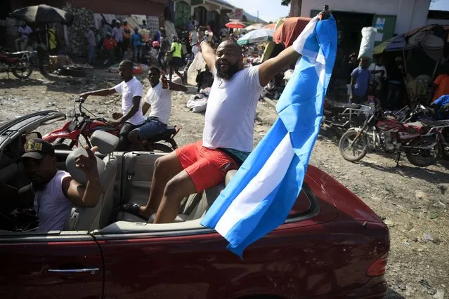 Soccer fans celebrate Argentina victory over France in the World Cup final soccer match in Port-au-Prince, Haiti, Sunday, December 18, 2022. (Photo by Odelyn Joseph/AP Photo)