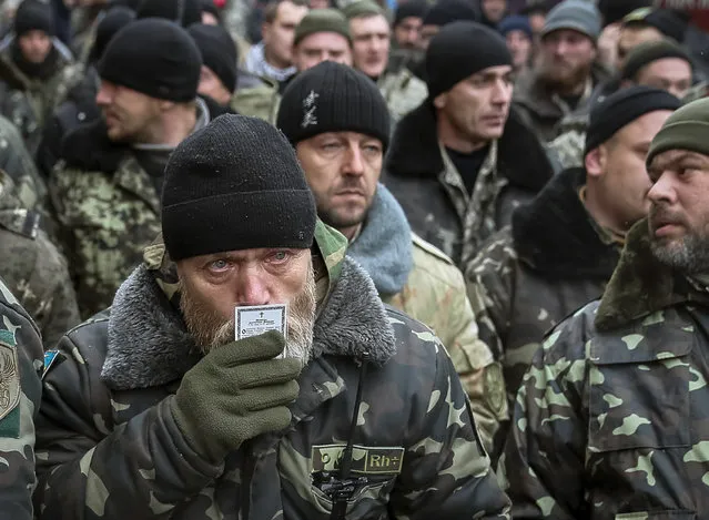 A serviceman of “Kiev 12” military defence battalion kisses an icon as he prepares takes part in a welcoming ceremony in central Ukrainian capital Kiev December 6, 2014. (Photo by Gleb Garanich/Reuters)