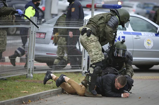 Police detain a man during an opposition rally to protest the official presidential election results in Minsk, Belarus, Sunday, November 1, 2020. Nearly three months after Belarus' authoritarian president's re-election to a sixth term in a vote widely seen as rigged, the continuing rallies have cast an unprecedented challenge to his 26-year rule. (Photo by AP Photo/Stringer)