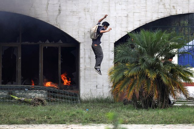 A demonstrator jumps from the gate of the Parliament during a protest against corruption and the government’s decision to block several social media platforms, in Kathmandu, Nepal on September 8, 2025. (Photo by Navesh Chitrakar/Reuters)