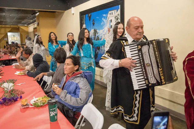 Traditional musicians and dancers entertain as Iranian-American volunteers cook and serve food for homeless and near-homeless people at Midnight Mission shelter on Skid Row to celebrate Nowruz in Los Angeles, California on March 16, 2018. (Photo by Monica Almeida/Reuters)