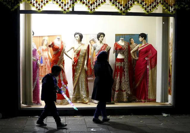 A boy plays with a light sabre after the switching on of Diwali lights in Leicester, Britain November 1, 2015.  The Diwali celebrations in Leicester are one of the largest in the world outside of India, with around 35,000 people attending the switch-on of the lights in the heart of the city's Asian community. (Photo by Darren Staples/Reuters)