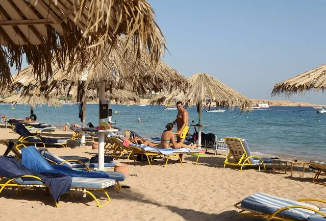 Tourists sunbath by the beach in the Red Sea resort of Sharm el-Sheikh, November 7, 2015. (Photo by Asmaa Waguih/Reuters)