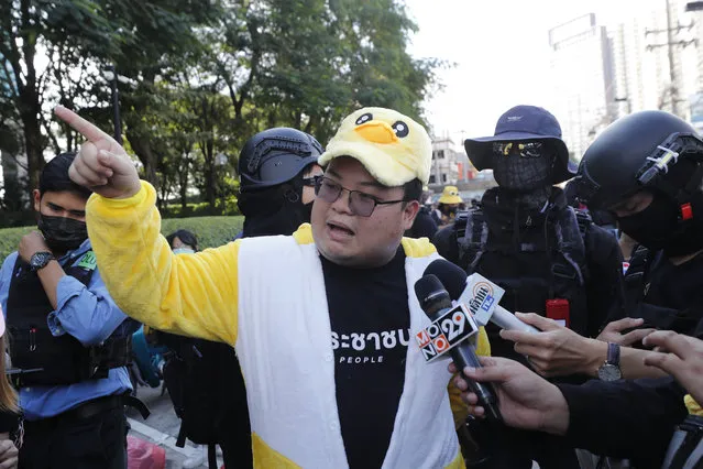 Protest leader Parit “Penguin” Chiwarak speaks to the media while wearing an outfit of a yellow duck, which has become a good-humored symbol of resistance during anti-government rallies, Wednesday, November 25, 2020, in Bangkok Thailand. (Photo by Sakchai Lalit/AP Photo)