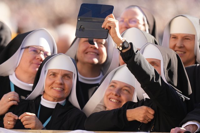 Nuns take a selfie as they attend the Pope Leo XIV holding his weekly general audience in St. Peter's Square, at the Vatican, Wednesday, October 8, 2025. (Photo by Andrew Medichini/AP Photo)