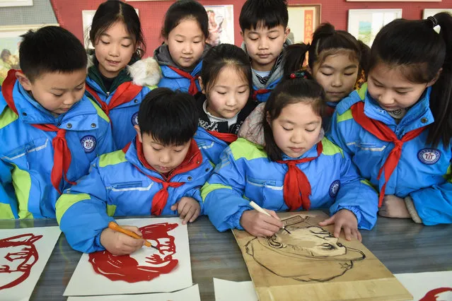 Students do paper cutting portraits of the late former Chinese Communist Party leader Mao Zedong ahead of his 127th birthday which falls on December 26, in Lianyungang in eastern China's Jiangsu province on December 23, 2020. (Photo by AFP Photo/China Stringer Network)