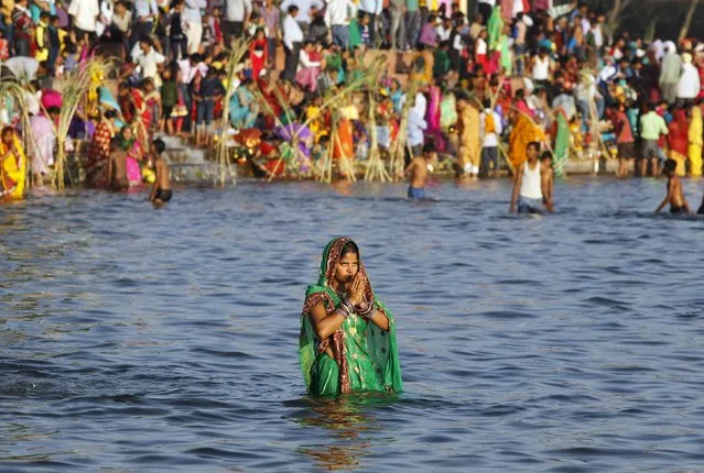 A Hindu woman worships the Sun god Surya in the waters of a lake during the Hindu religious festival of Chatt Puja in Chandigarh, India, November 17, 2015. Hindu women fast for the whole day for the betterment of their family and the society during the festival. (Photo by Ajay Verma/Reuters)