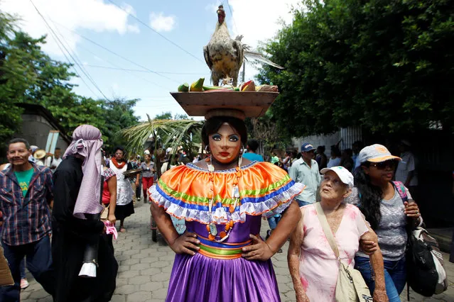A performer dances during the annual “Torovenado del Pueblo” festival, held in honour of San Jeronimo, the patron saint of the city of Masaya, Nicaragua October 30, 2016. (Photo by Oswaldo Rivas/Reuters)