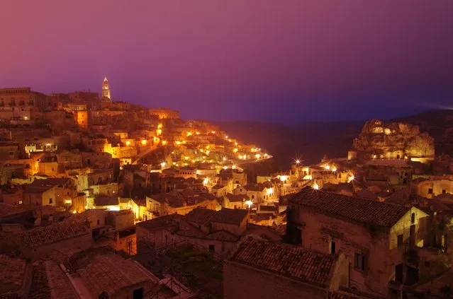 “Light up”. Dusky fog gently descending upon the ancient cave settlement of Sassi di Matera as the town lit up. Location: Matera, Basilicata, Italy (Photo and caption by Chen Fei/National Geographic Traveler Photo Contest)