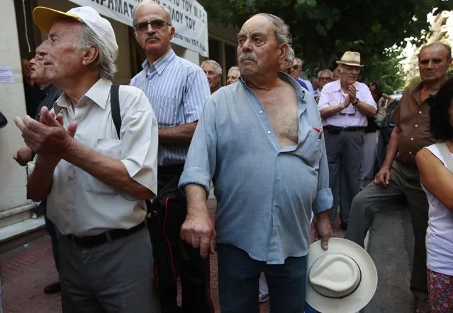 Pensioners applaud in front of the Health Ministry as they take part in an anti-austerity rally in Athens in this September 4, 2012 file photo. (Photo by John Kolesidis/Reuters)