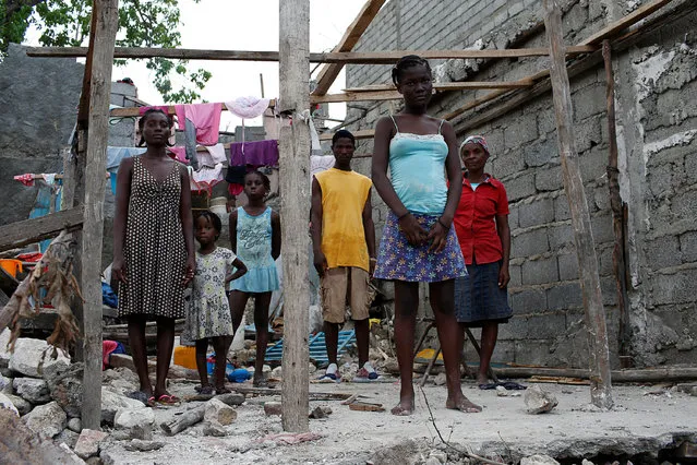 Roseline Charles (R), 57, poses for a photograph next to her relatives in their destroyed house after Hurricane Matthew hit Jeremie, Haiti, October 15, 2016. “As you can see, my house was completely destroyed, we lost everything. None of us died during the hurricane but we are homeless now”, said Charles. (Photo by Carlos Garcia Rawlins/Reuters)