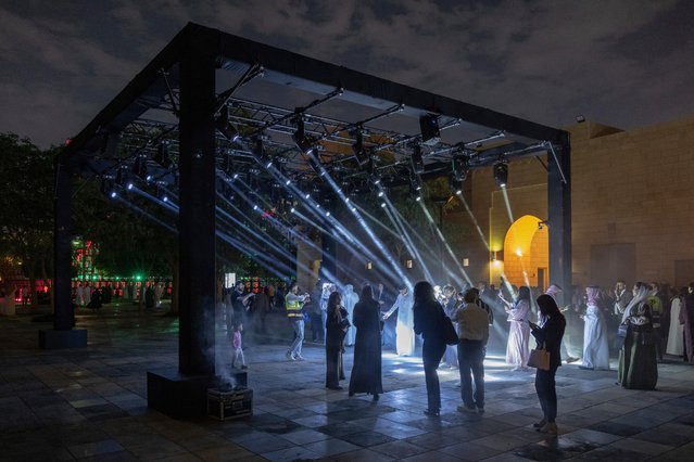 In this image released on Monday, Dec. 2, 2024, guests interact with Alone Together (2024), an immersive installation that uses light beams to engage with the viewer in unexpected ways, on the preview day of Noor Riyadh 2024 on Tuesday, November 26, 2024 in Riyadh. The festival features more than 60 large-scale artworks that explore the relationship between the physical and the metaphysical. (Photo by Naif Alquba/AP Content Services for Noor Riyadh)