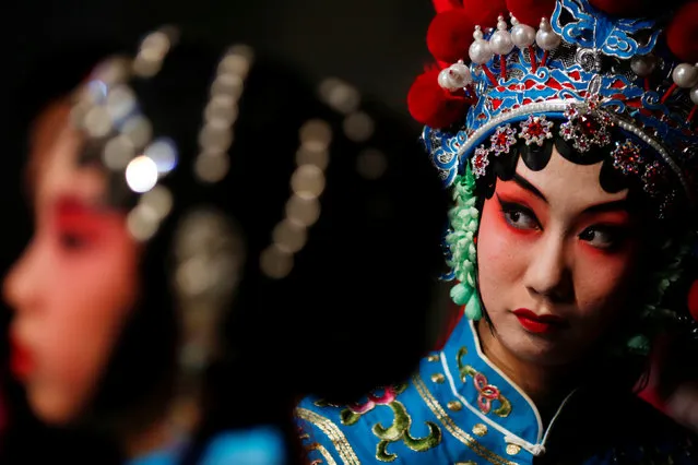 Participants wait for their turn backstage during a traditional Chinese opera competition at the National Academy of Chinese Theatre Arts in Beijing, China, November 26, 2016. (Photo by Thomas Peter/Reuters)