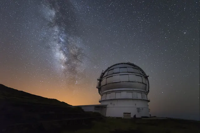 In this image released on Wednesday, July 11, 2018, the Milky Way, visible in the skies above the Gran Telescopio Canarias at the Roque de los Muchachos Observatory on the island of La Palma in the Canaries, Spain. On July 27th Mars will be nearing the closest it's been to Earth in 15 years. This event, occurring in parallel to the longest lunar eclipse of the 21st century, creates a unique experience offered to six guests on Airbnb to visit the telescope and view the night sky from one of the best stargazing spots on the planet. (Photo by Antoni Cladera/Airbnb via AP Images)