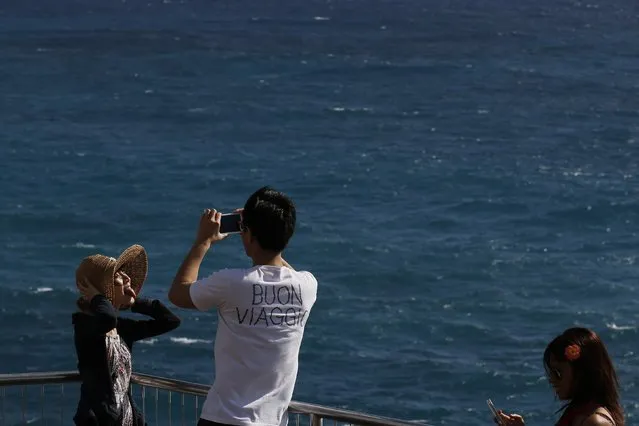 Young people take pictures at the Halona Blowhole Lookout in Honolulu, Hawaii December 27, 2015. (Photo by Jonathan Ernst/Reuters)
