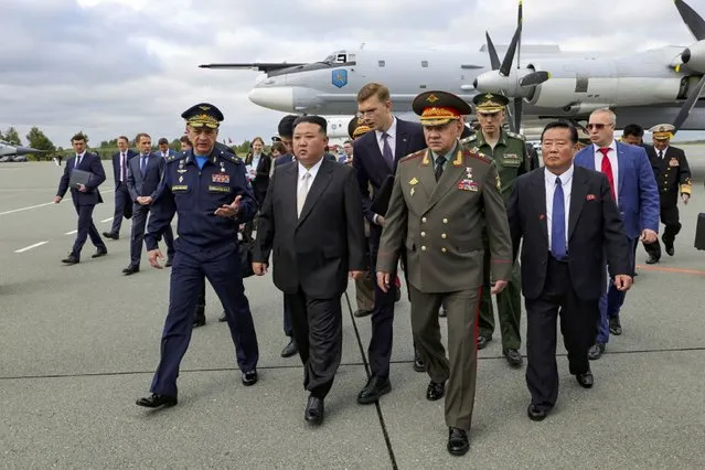 In this photo released by Russian Defense Ministry Press Service, North Korea's leader Kim Jong Un, center, and Russian Defense Minister Sergei Shoigu, foreground right, arrive to inspect Russian warplanes at the Vladivostok International airport in Vladivostok, Russian Far East Saturday, September 16, 2023. (Photo by Russian Defense Ministry Press Service via AP Photo)