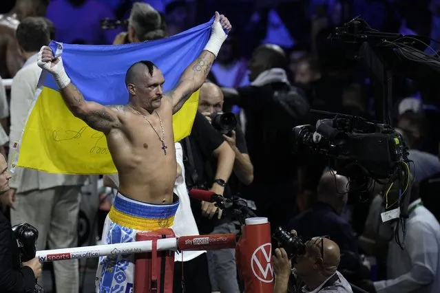 Ukraine's Oleksandr Usyk celebrates after beating Britain's Anthony Joshua to retain his world heavyweight title at King Abdullah Sports City in Jeddah, Saudi Arabia, Sunday, August 21, 2022. (Photo by Hassan Ammar/AP Photo)