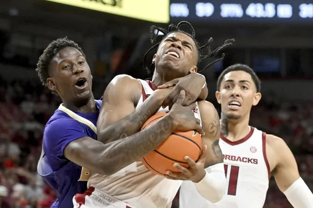 Arkansas guard Khalif Battle, center, is fouled by Alcorn State forward Willie Anderson Jr., left, as he drives to the hoop during the second half of an NCAA college basketball game Monday, November 6, 2023, in Fayetteville, Ark. Anderson was charged with a flagrant foul on the play. (Photo by Michael Woods/AP Photo)