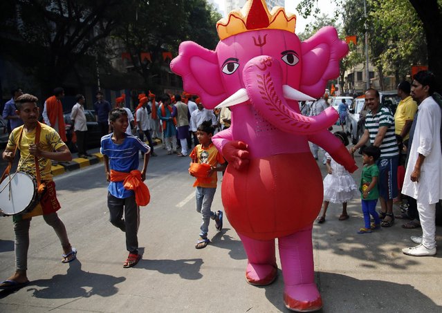 Indians participate in a procession celebrating “Gudi Padwa” or the Marathi New Year in in Mumbai, India, Saturday, March 21, 2015. People in the western Indian state of Maharashtra celebrate this day as New Year day. (Photo by Rajanish Kakade/AP Photo)