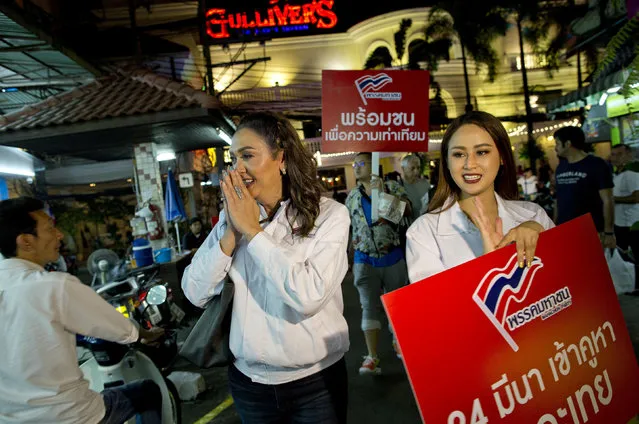 In this Wednesday, February 13, 2019, photo, a transgender person and a prime minister candidate Pauline Ngarmpring, center, and house candidate Namklenginarin, right, both representing the Mahachon party for the upcoming general election, greet people during an election campaign in Bangkok, Thailand. As Pinit Ngarmpring, he was a CEO and sports promoter, well known in the world of Thai soccer. Now, under her preferred new name of Pauline Ngarmpring, she's pursuing a bid to become the country's first transgender prime minister. (Photo by Gemunu Amarasinghe/AP Photo)