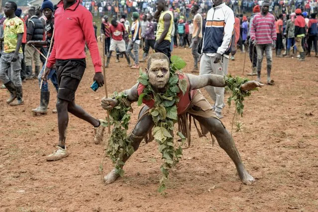 A spectator reacts during a bull fighting match to mark the new year on January 01, 2024 in Malinya, Kakamega County, Kenya. (Photo by Brian Ongoro/Getty Images)