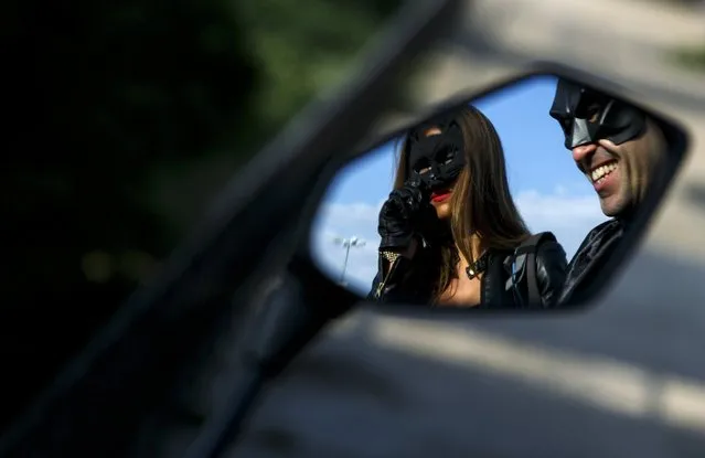 Participants wearing superhero costumes can be seen in a motorbike mirror before the World DC Comics Super Heroes event in San Martin de Valdeiglesias, near Madrid, April 18, 2015. (Photo by Andrea Comas/Reuters)