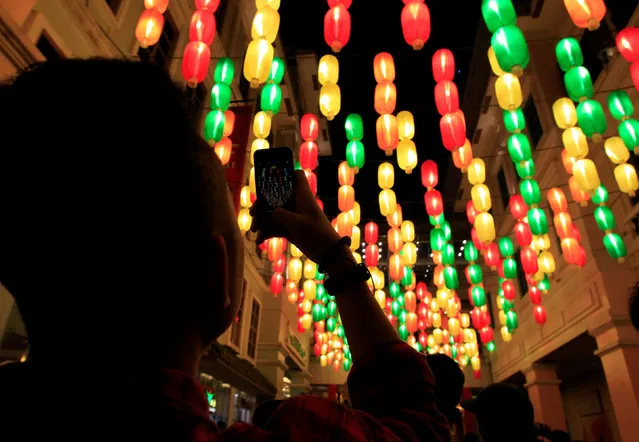 A man takes a picture of a lantern display during the Lunar New Year celebrations in Chinatown in Manila, Philippines January 28, 2017. (Photo by Czar Dancel/Reuters)